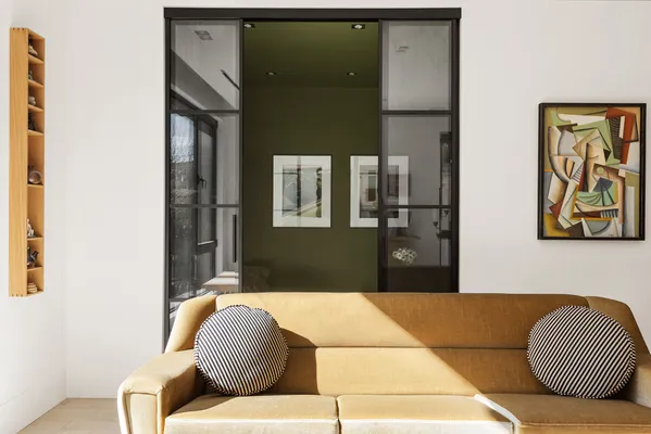 a living room with a couch and painting on the wall
