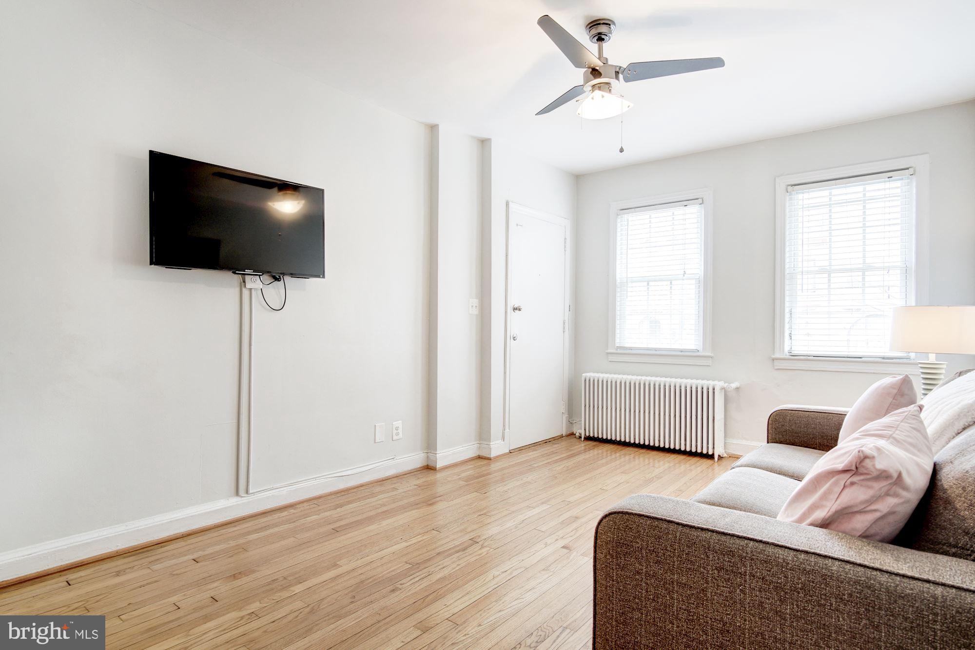 731 13th Street Northeast Washington, DC 20002 - Photo 28 of 43 a living room with furniture and a flat screen tv