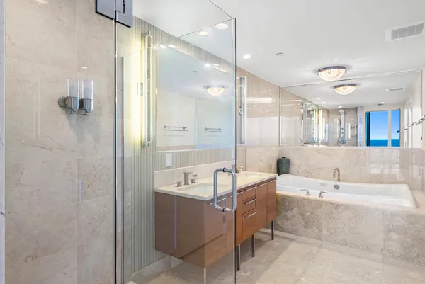 a bathroom with a shower sink and mirror