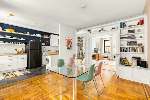 a living room with stainless steel appliances kitchen island granite countertop furniture and a dining table