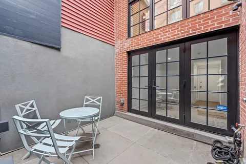 a backyard of a house with table and chairs
