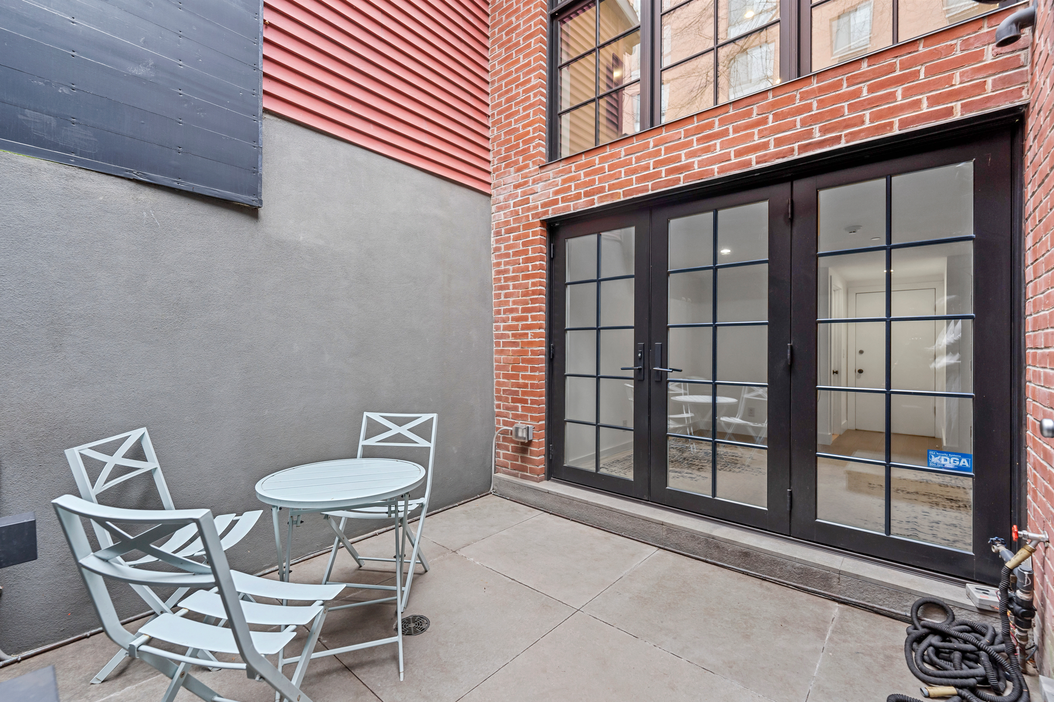 440 West 20th Street Manhattan, NY 10011 - Photo 29 of 35 a backyard of a house with table and chairs