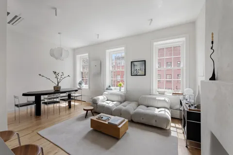 a living room with furniture wooden floor and a table