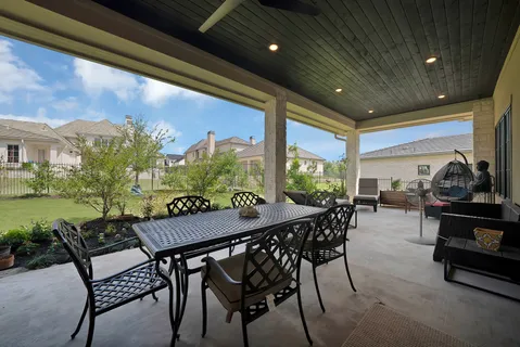 a view of a patio with a table and chairs and potted plants