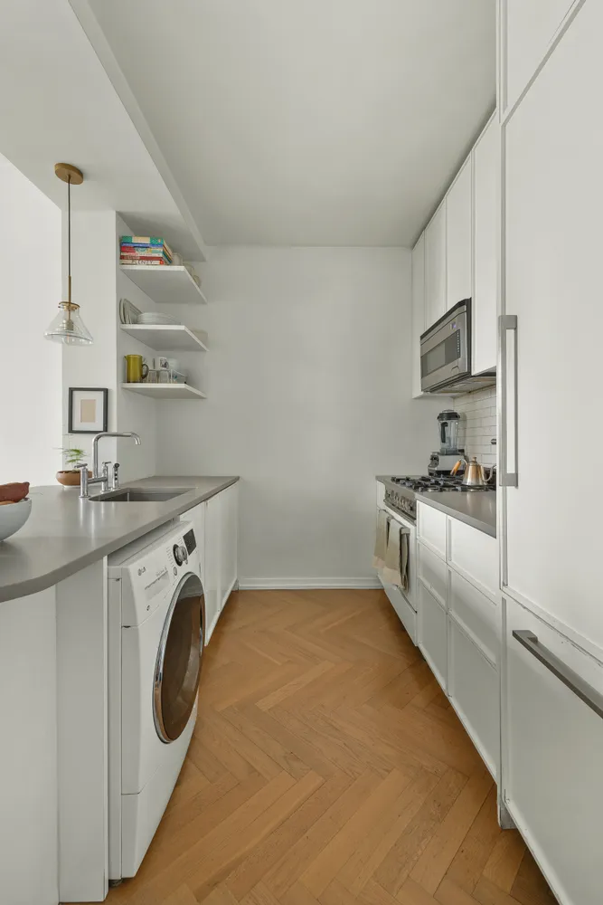 a utility room with cabinets washer and dryer