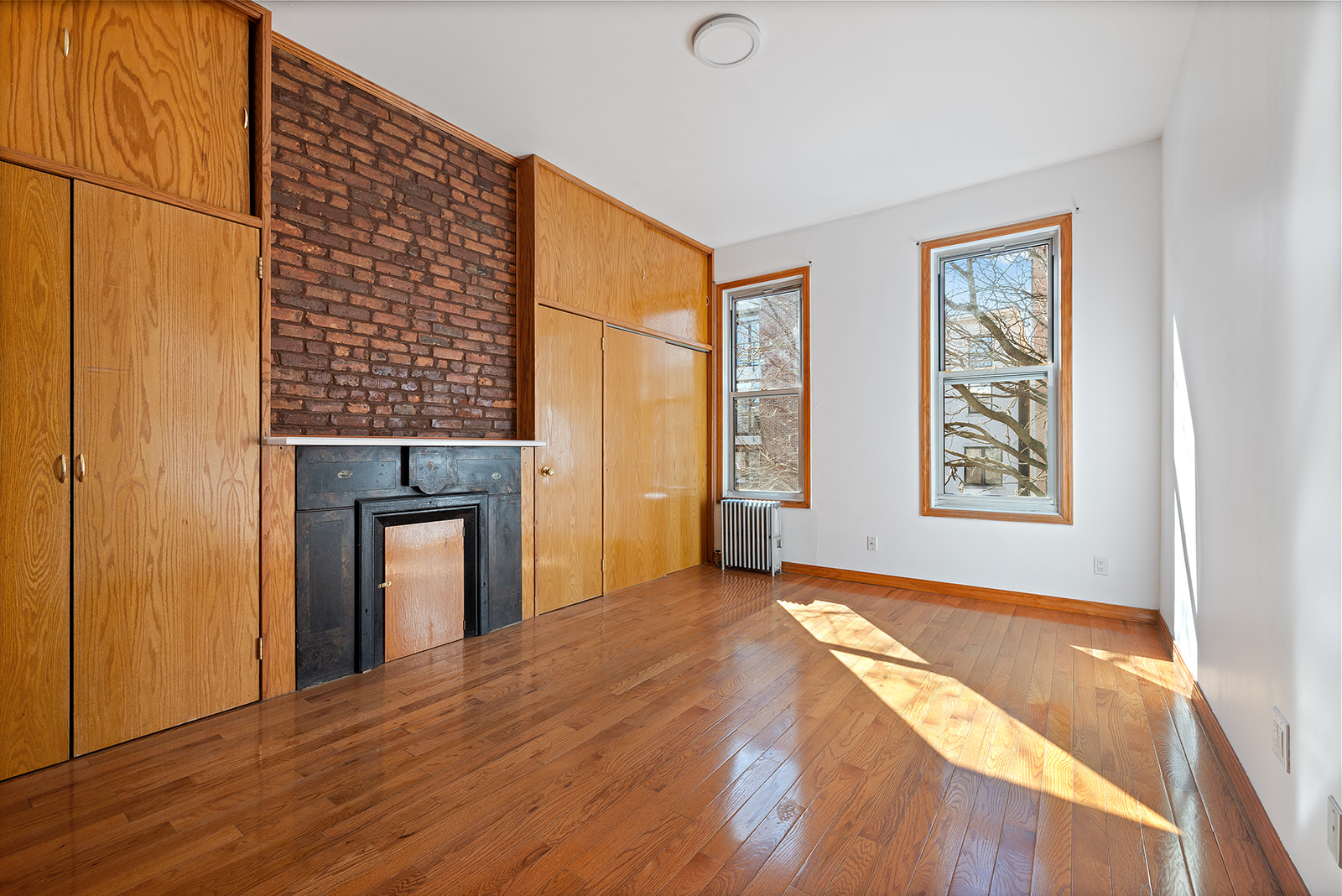 83 Maujer Street, Unit 2R Brooklyn, NY 11206 - Photo 1 of 6 a view of an empty room with window and wooden floor