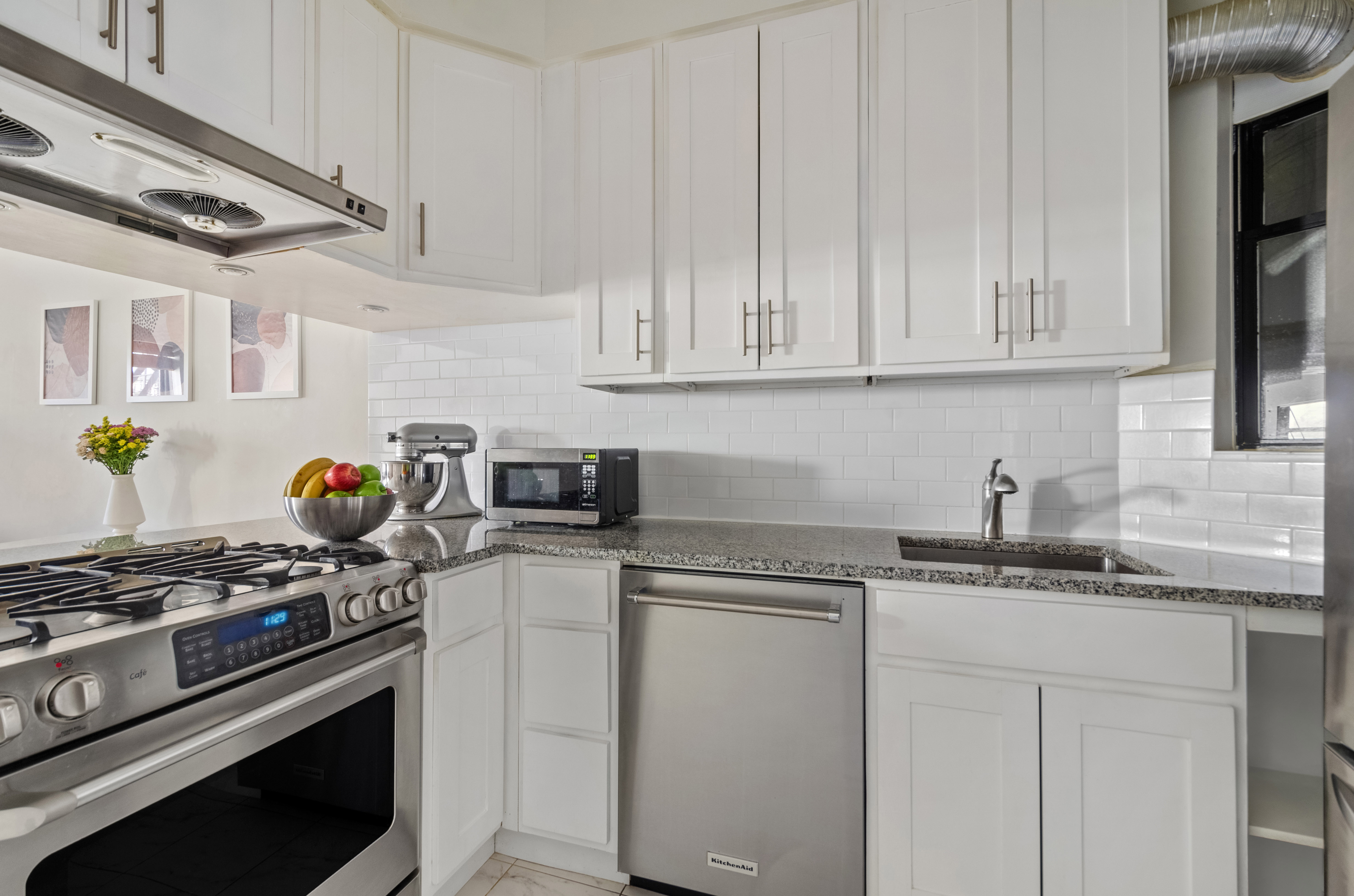 412 7th Avenue, Unit 2R Brooklyn, NY 11215 - Photo 4 of 9 a kitchen with stainless steel appliances granite countertop a sink a stove and cabinets