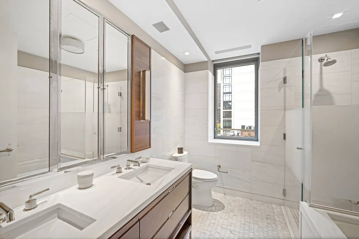 a bathroom with a tub sink toilet and mirror