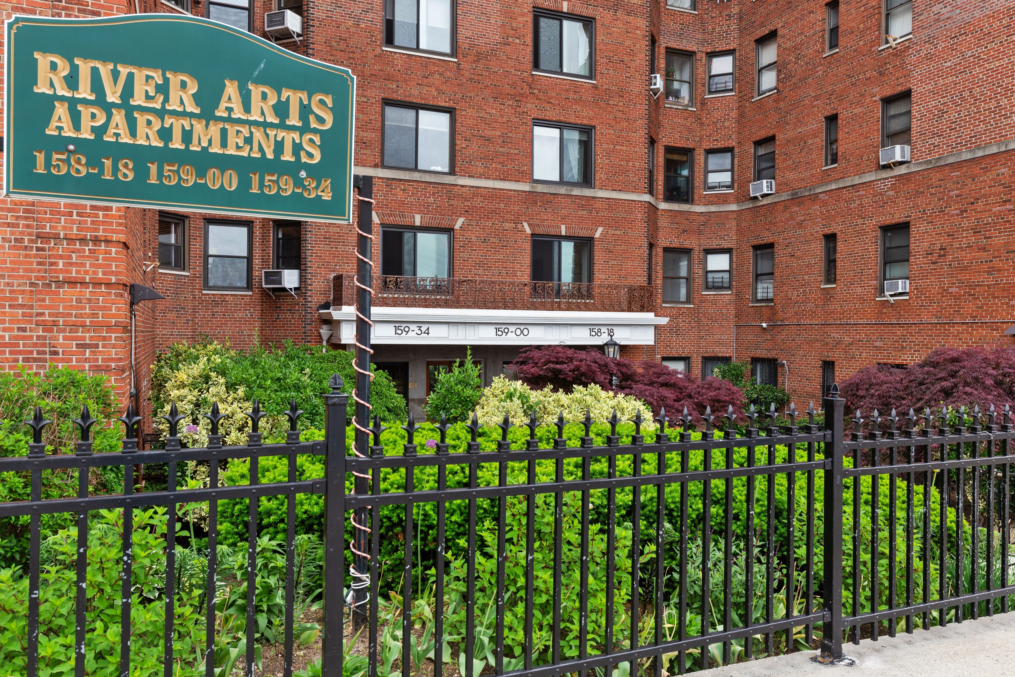 158-18 Riverside Drive West, Unit 2E Manhattan, NY 10032 - Photo 16 of 22 a front view of a multi story building with a yard