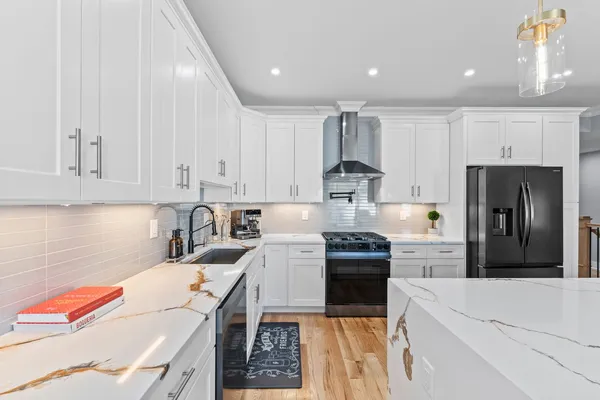 a kitchen with a sink a stove and cabinets