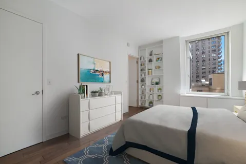 a bedroom with a bed and a window in it