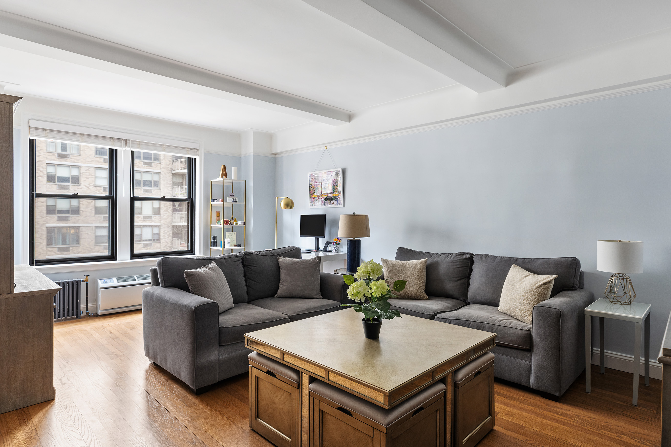 308 East 79th Street, Unit 9E Manhattan, NY 10075 - Photo 2 of 7 a living room with furniture and a potted plant on the table