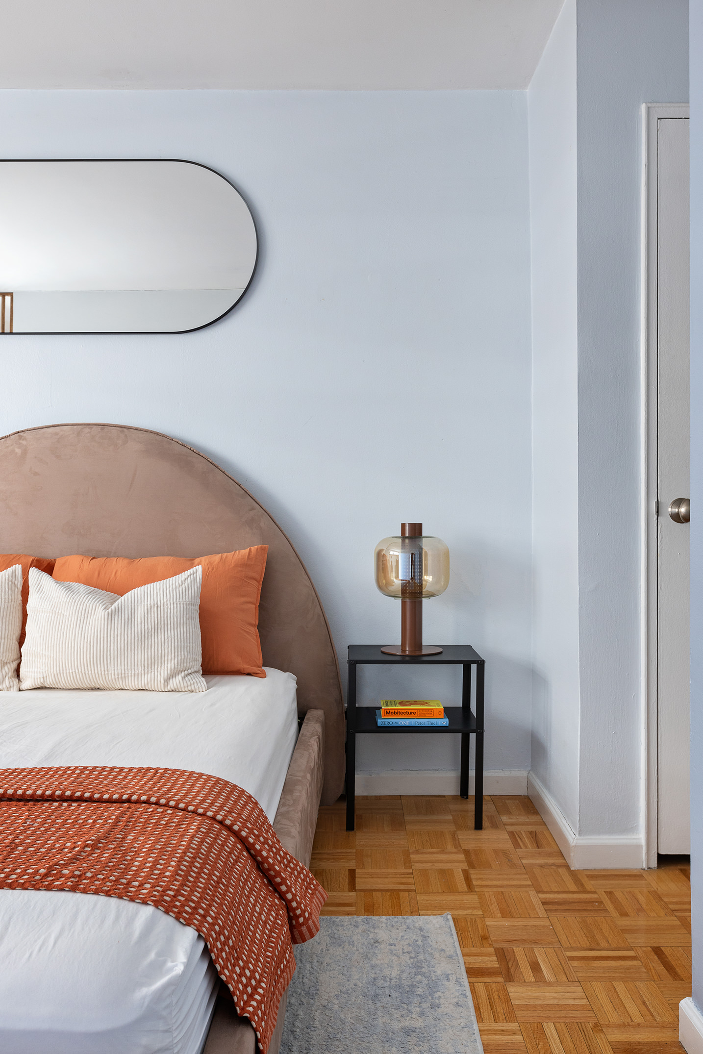 235 East 87th Street, Unit 5G Manhattan, NY 10128 - Photo 6 of 13 a bedroom with a bed and a lamp