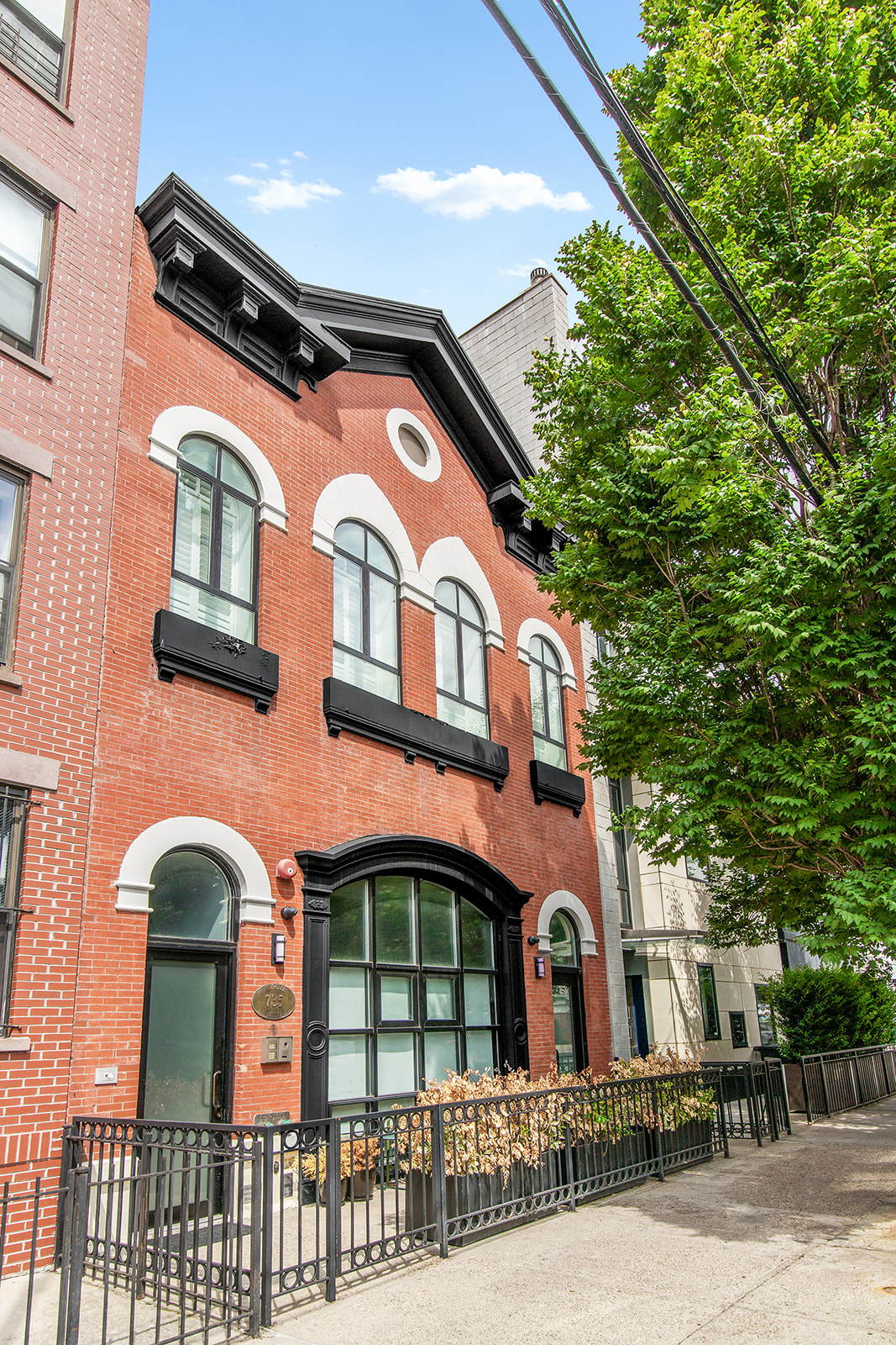 735 Dean Street, Unit 2B Brooklyn, NY 11238 - Photo 10 of 11 a front view of a residential apartment building with a yard
