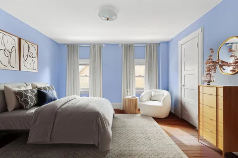 a spacious bedroom with a bed and a couch