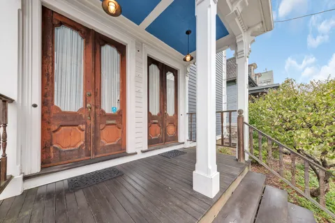 a view of an entryway with wooden floor and door