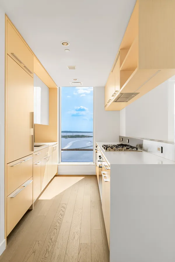 a view of a kitchen with a sink and a window