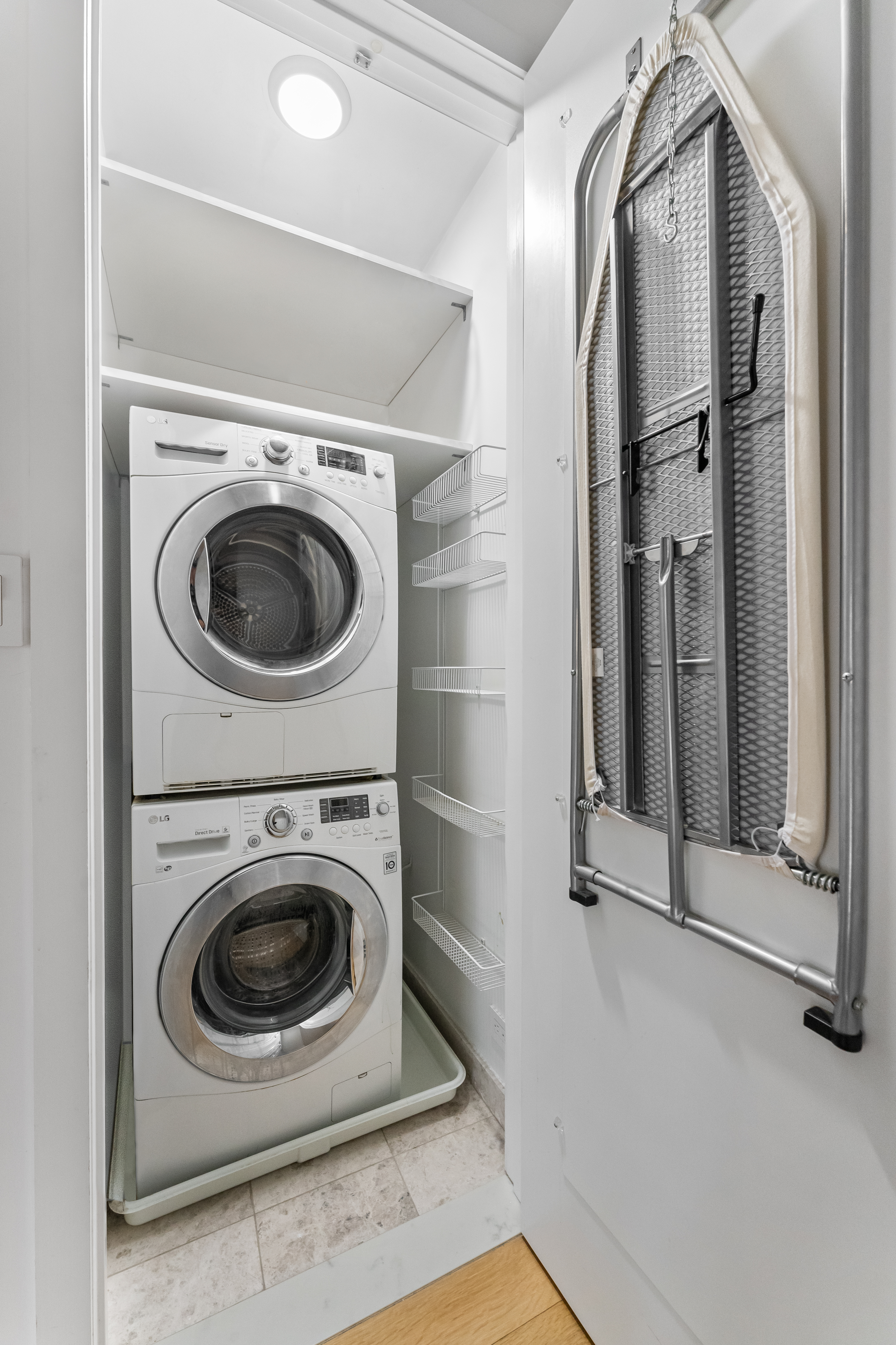 20 East 68th Street, Unit 11C Manhattan, NY 10065 - Photo 8 of 11 a utility room with dryer and washer