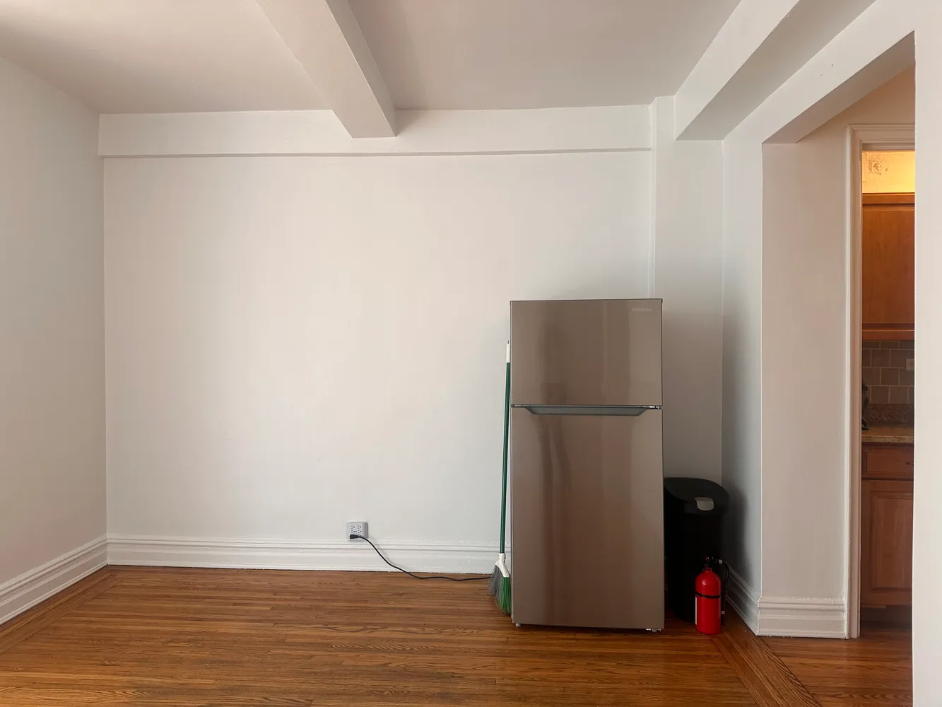 a view of a room with wooden floor