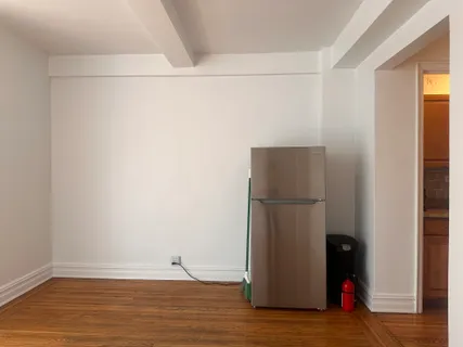 a view of a room with wooden floor