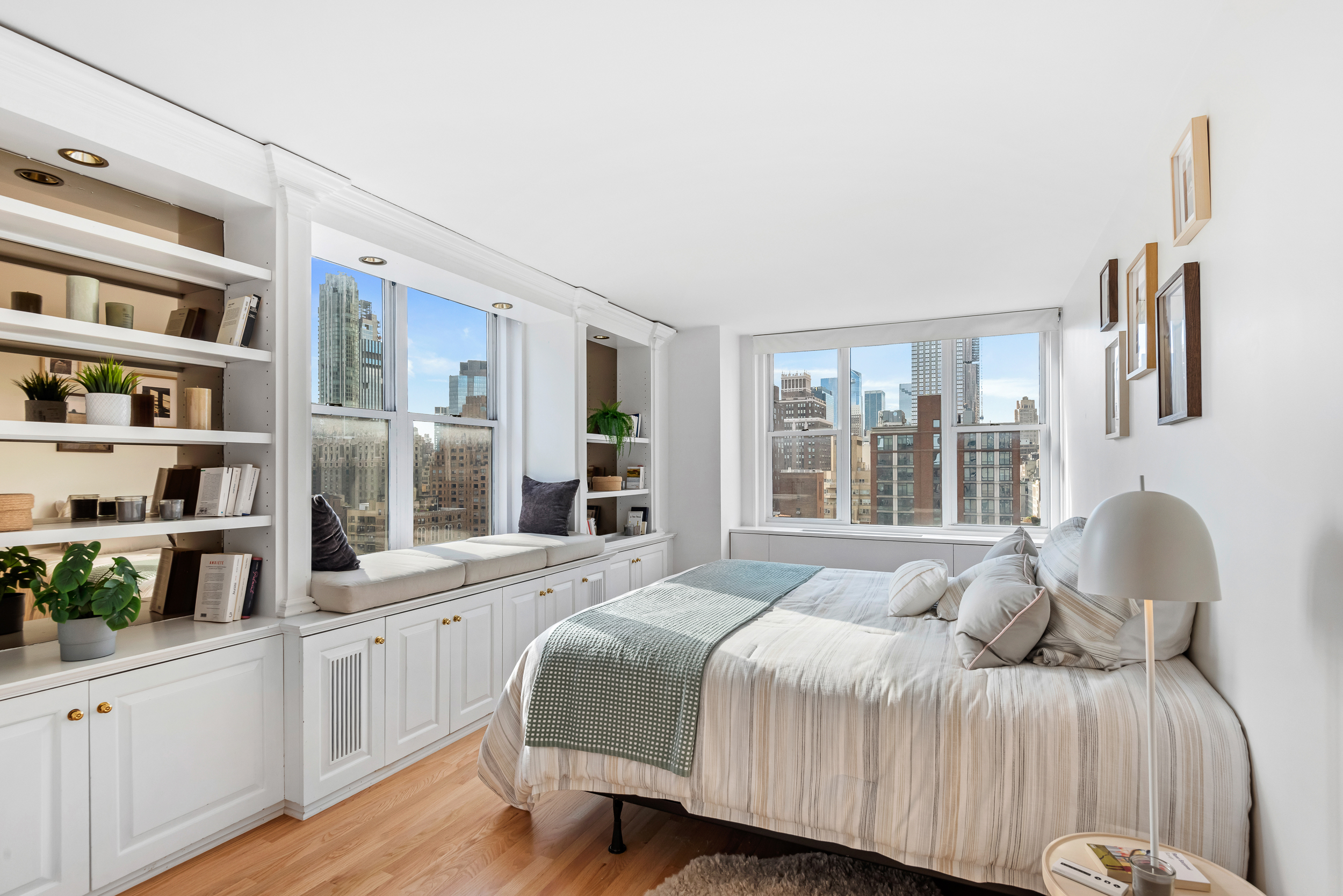 137 East 36th Street, Unit 21F Manhattan, NY 10016 - Photo 8 of 18 a bedroom with a bed and a large window with the outer view