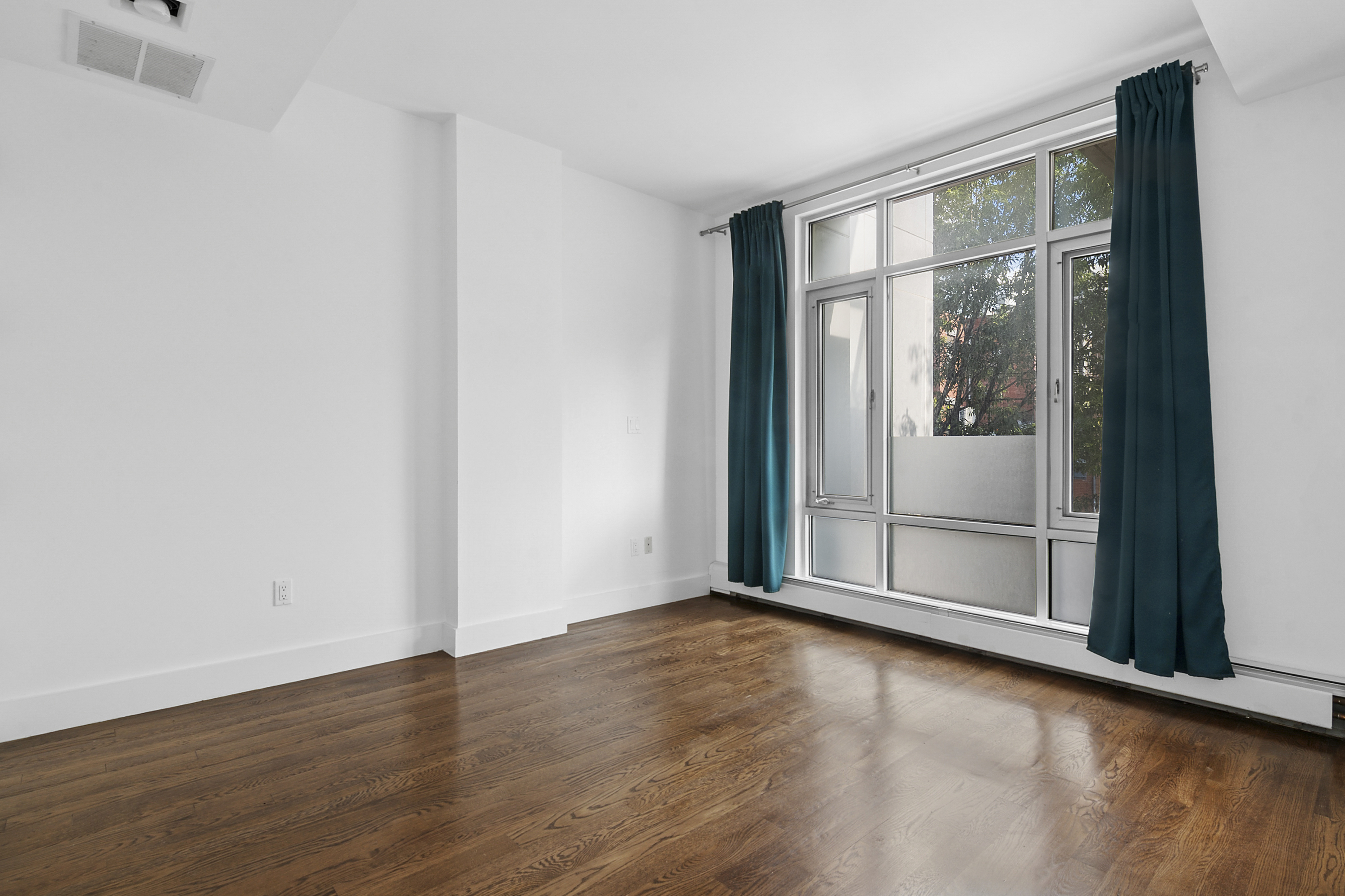 238 Saint Marks Avenue, Unit 2A Brooklyn, NY 11238 - Photo 4 of 6 a view of an empty room with wooden floor and a window