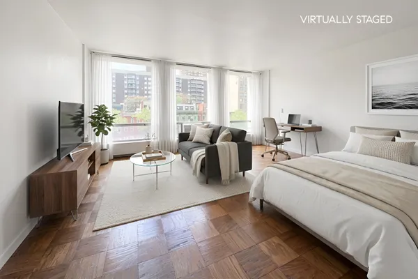 a spacious bedroom with two beds and a flat screen tv