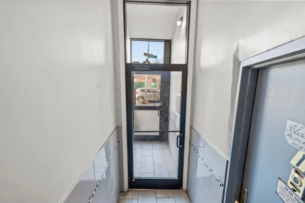 a view of entryway and gallery with wooden floor