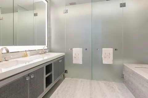 a bathroom with a granite countertop sink a toilet and shower