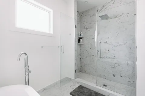 a bathroom with a shower and toilet