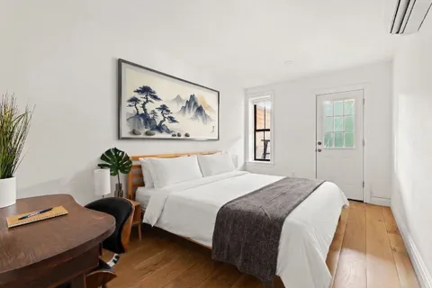 a bedroom with a bed and a desk