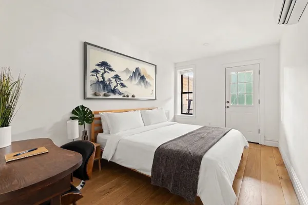 a bedroom with a bed and a desk