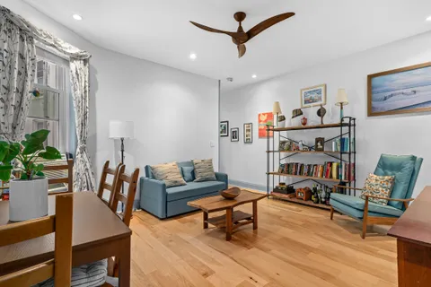 a living room with furniture and a book shelf