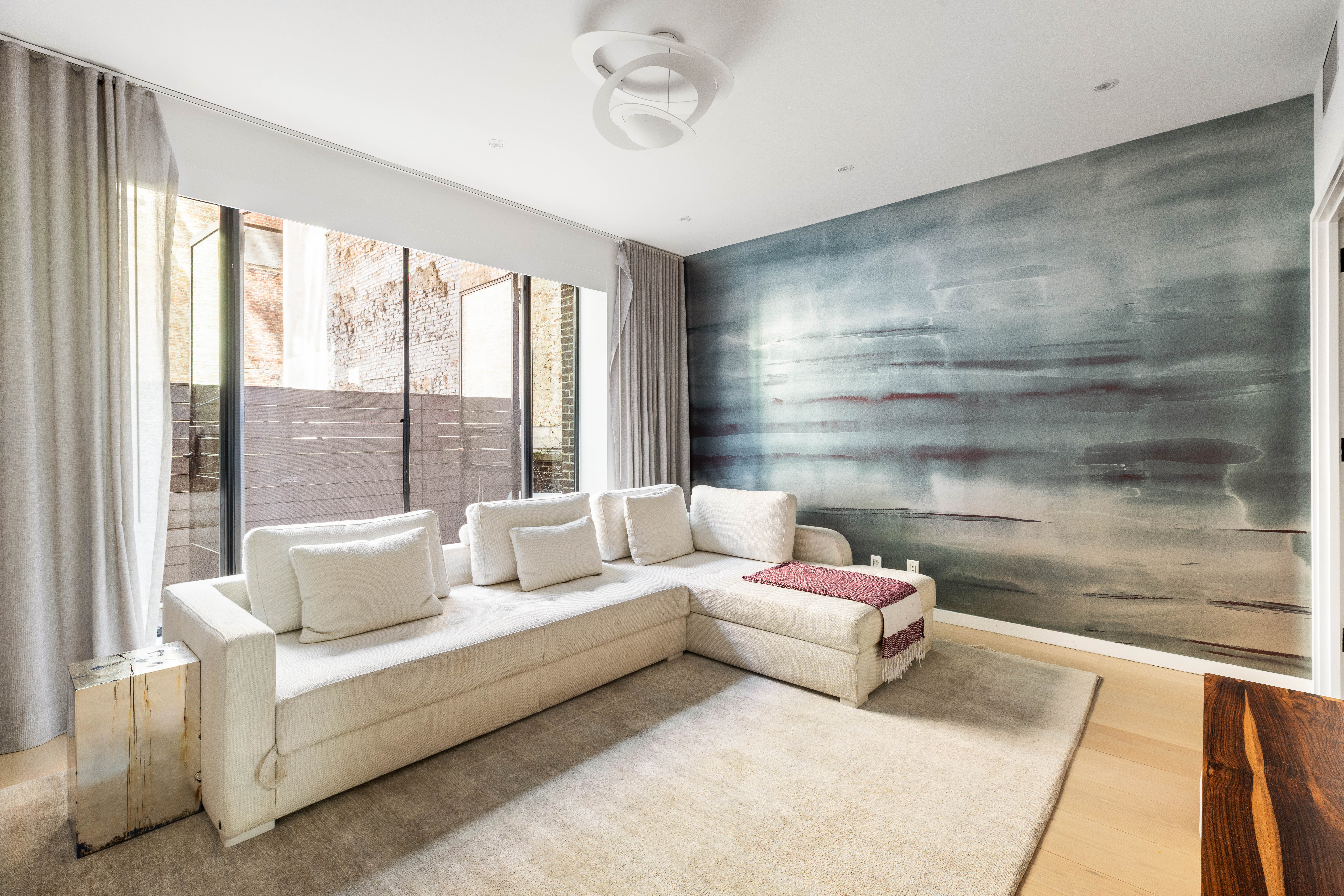 456 West 19th Street, Unit 2/3F Manhattan, NY 10011 - Photo 11 of 14 a living room with furniture and a large window