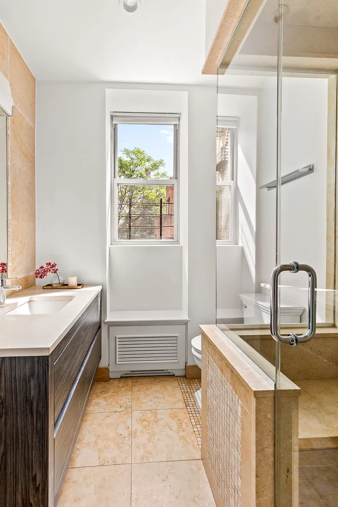 a bathroom with a tub sink and mirror