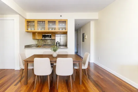 a view of a dining room with furniture and wooden floor