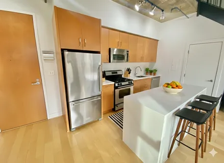 a kitchen with stainless steel appliances a refrigerator sink and stove