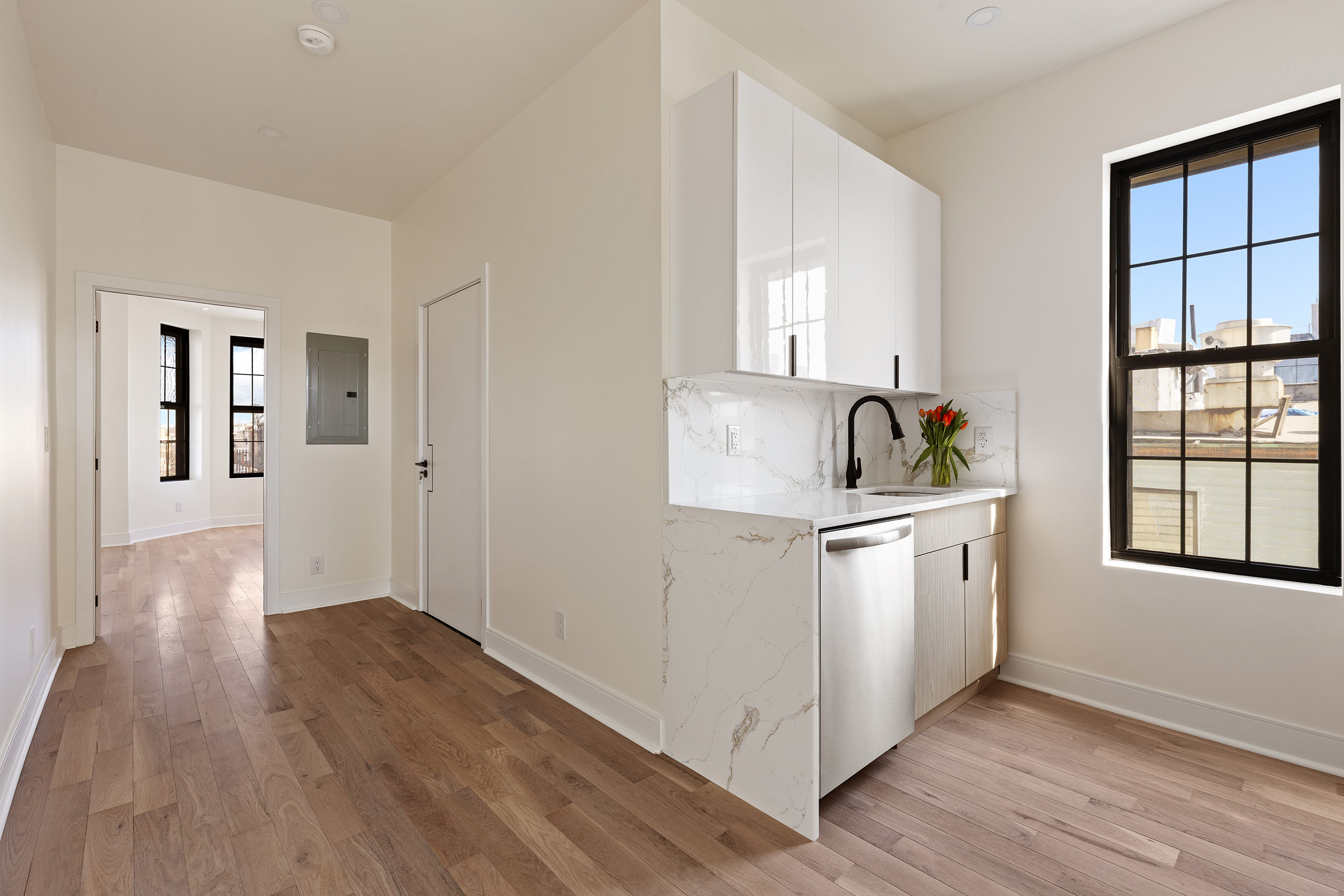 152 North 10th Street, Unit 1R Brooklyn, NY 11249 - Photo 7 of 18 a kitchen with wooden floor and window