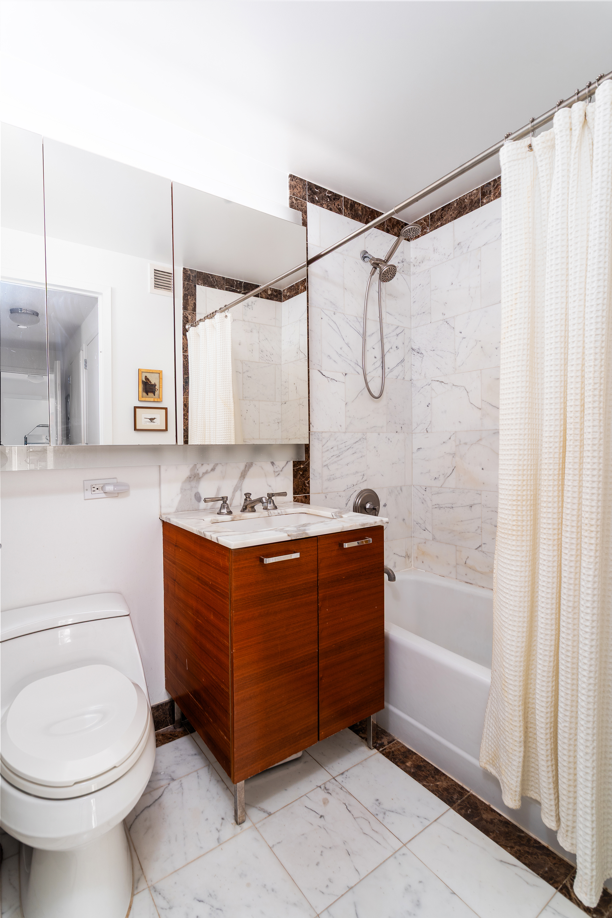 415 Main Street, Unit 7C Manhattan, NY 10044 - Photo 11 of 16 a bathroom with a sink toilet and shower