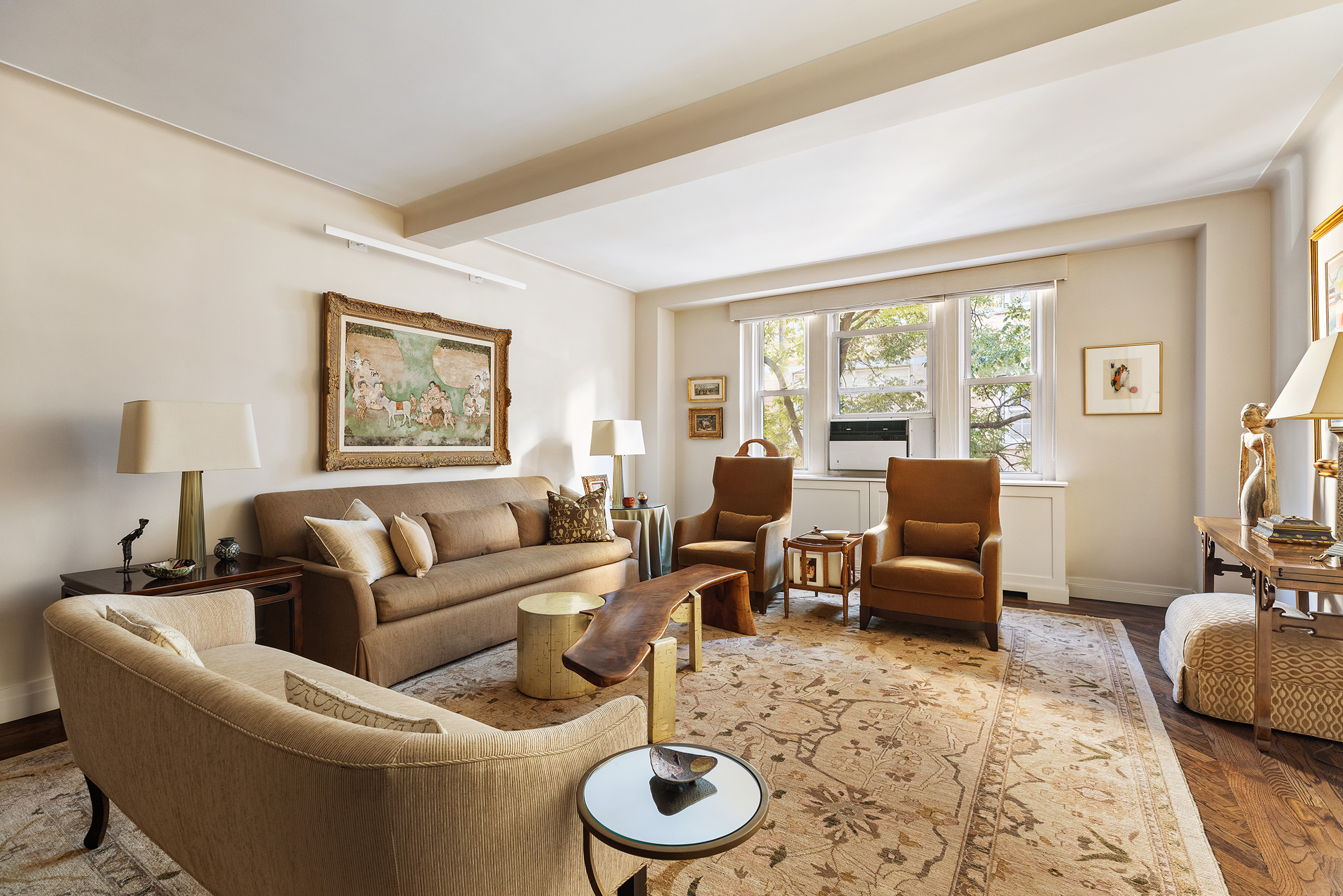 a living room with furniture and a floor to ceiling window