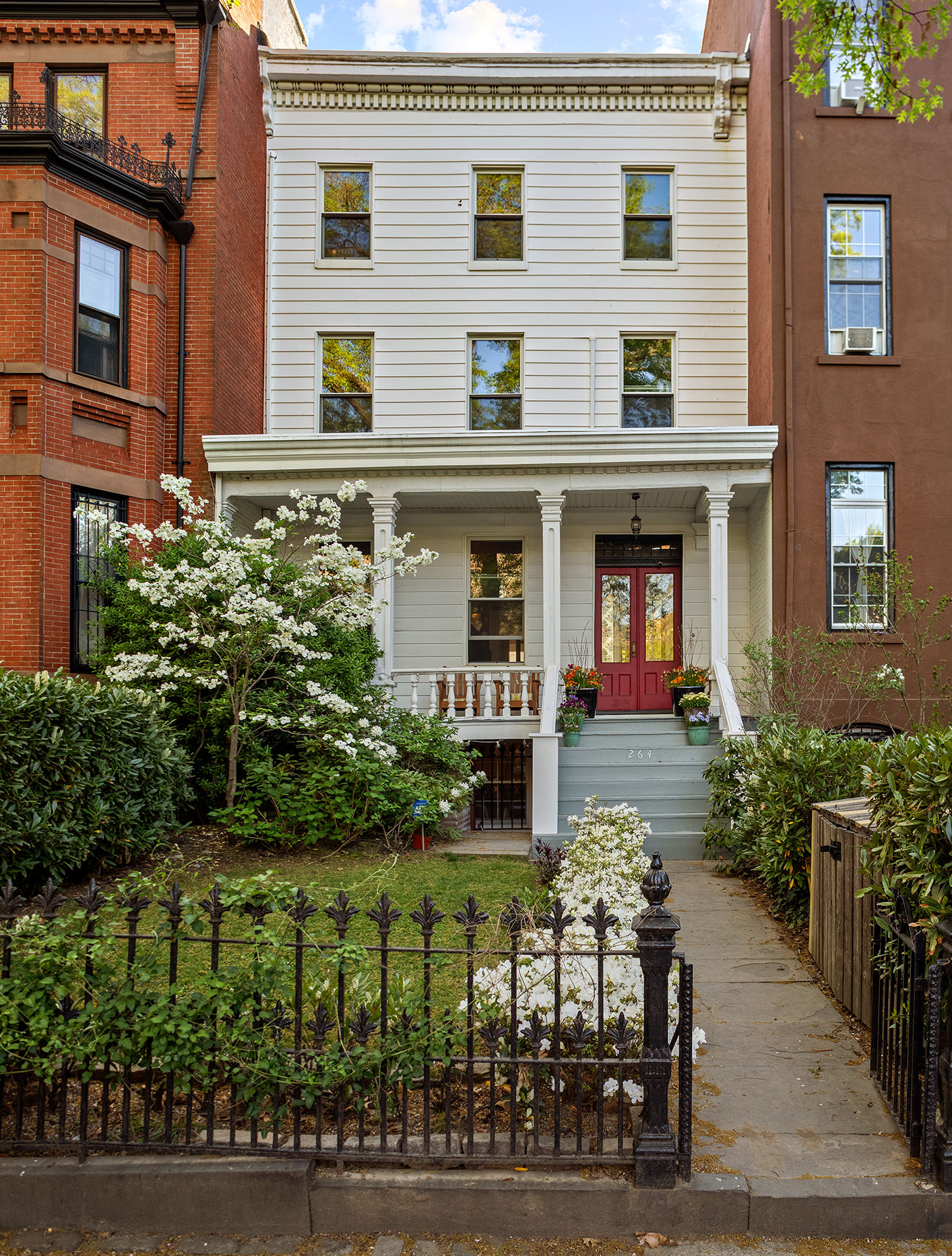 264 Clinton Avenue Brooklyn, NY 11205 - Photo 20 of 21 a front view of a house with a yard