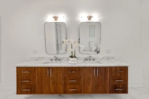 a bathroom with a double vanity sink and a mirror