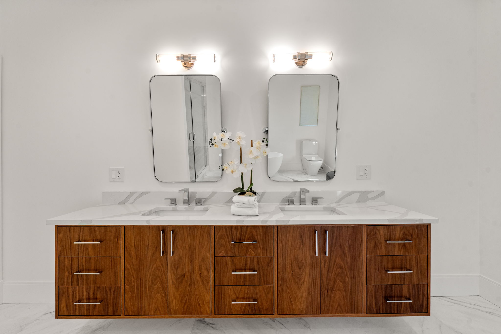 20 Oakland Street Wellesley, MA 02481 - Photo 13 of 30 a bathroom with a double vanity sink and a mirror