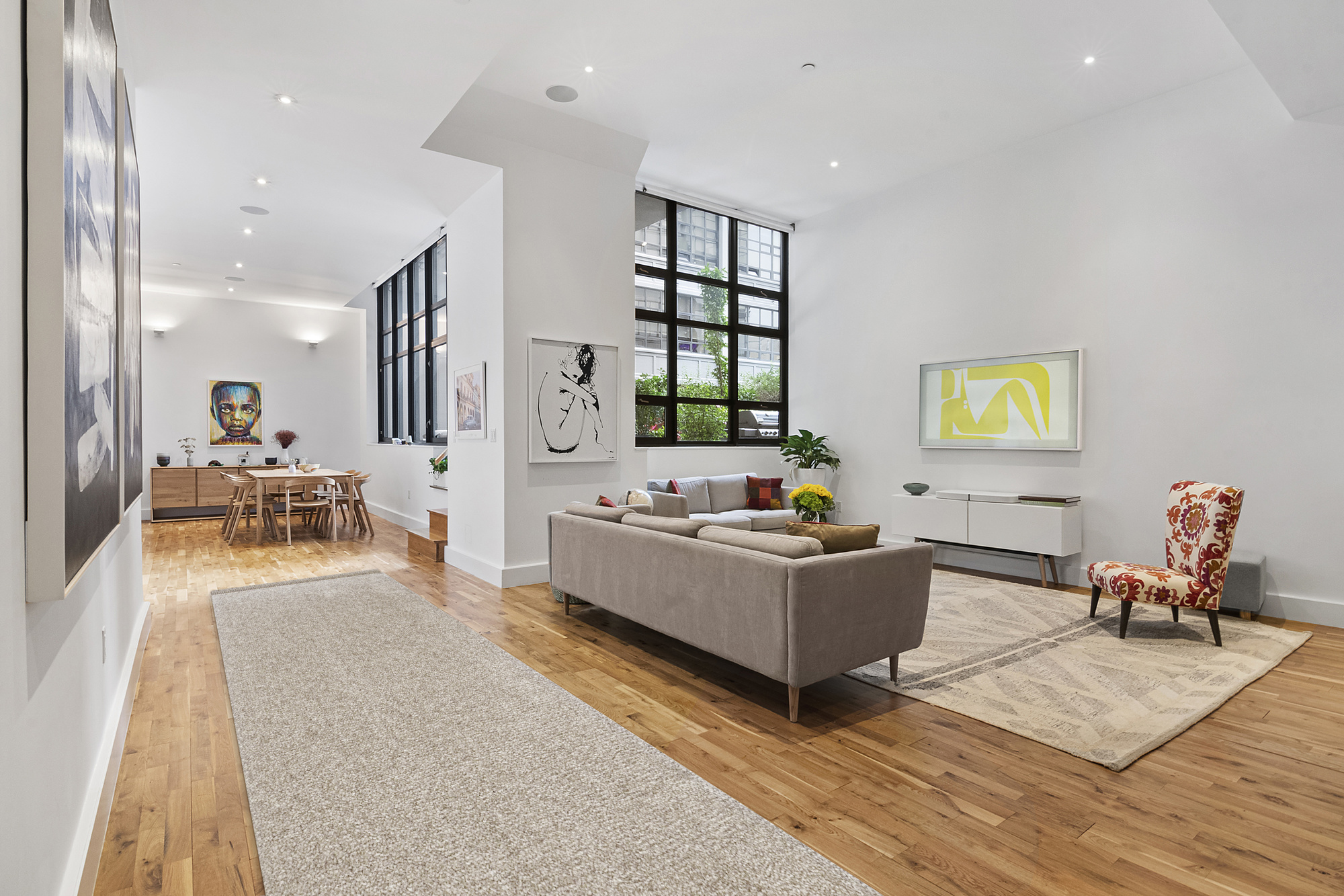 360 Furman Street, Unit 320/321 Brooklyn, NY 11201 - Photo 2 of 28 a living room with furniture and wooden floor