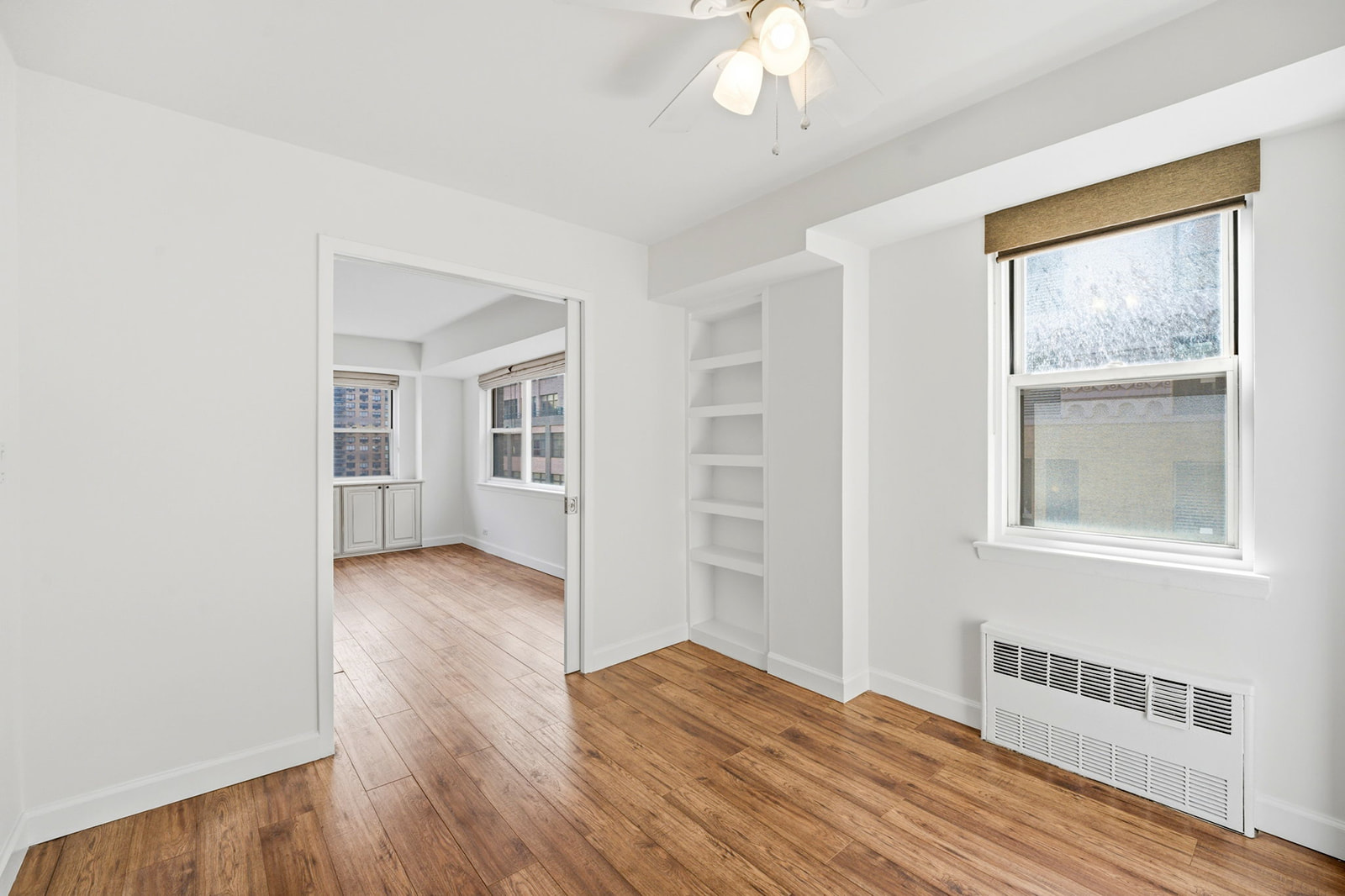 139 East 33rd Street, Unit 12DE Manhattan, NY 10016 - Photo 18 of 27 a view of empty room with wooden floor and fan