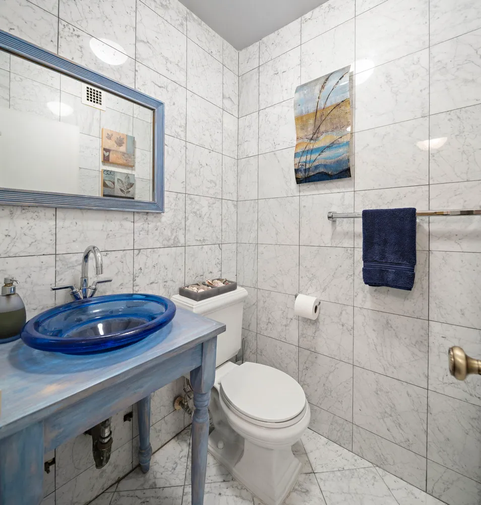 a bathroom with a toilet sink and mirror