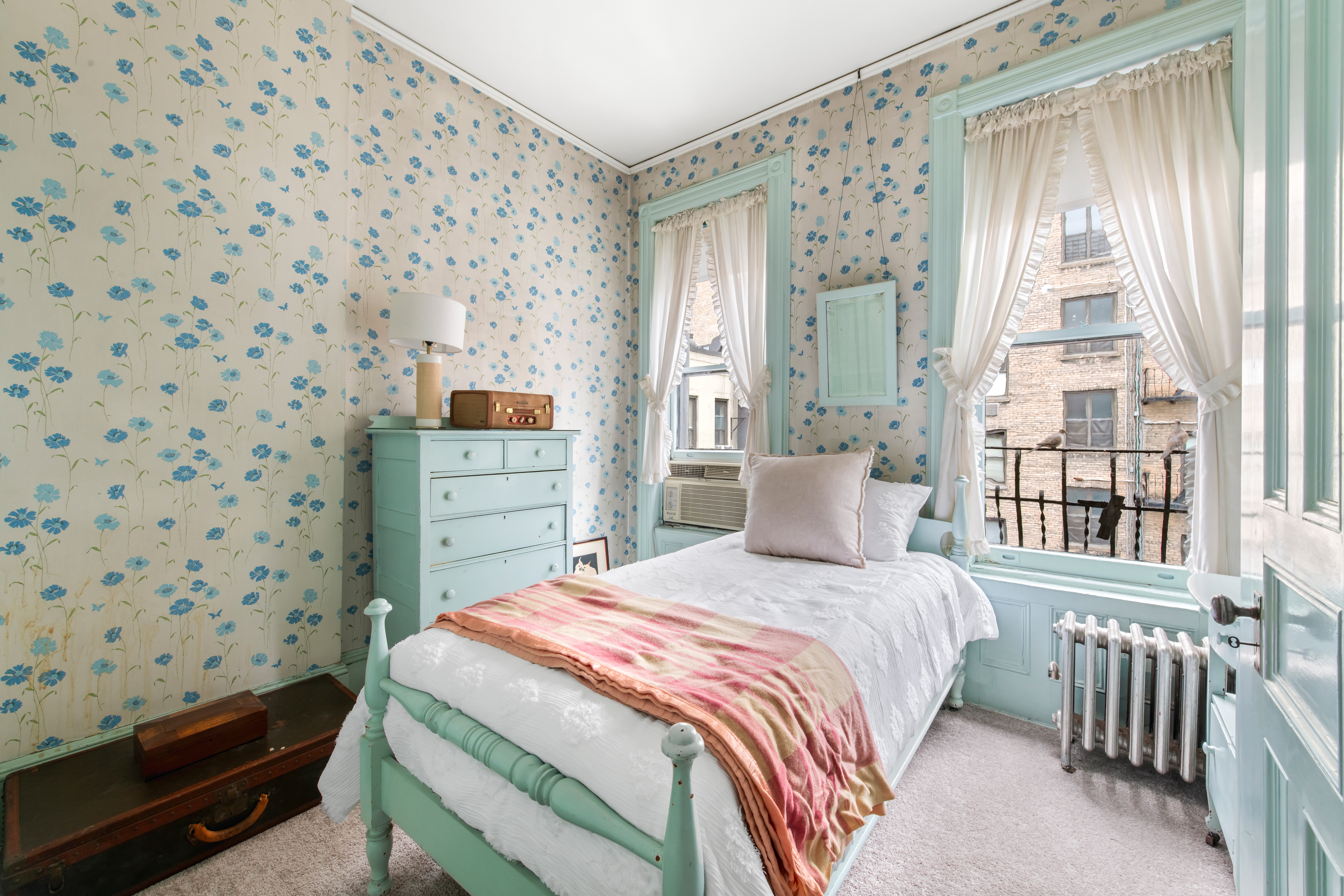 155 East 70th Street Manhattan, NY 10021 - Photo 16 of 27 a bedroom with a bed and a window