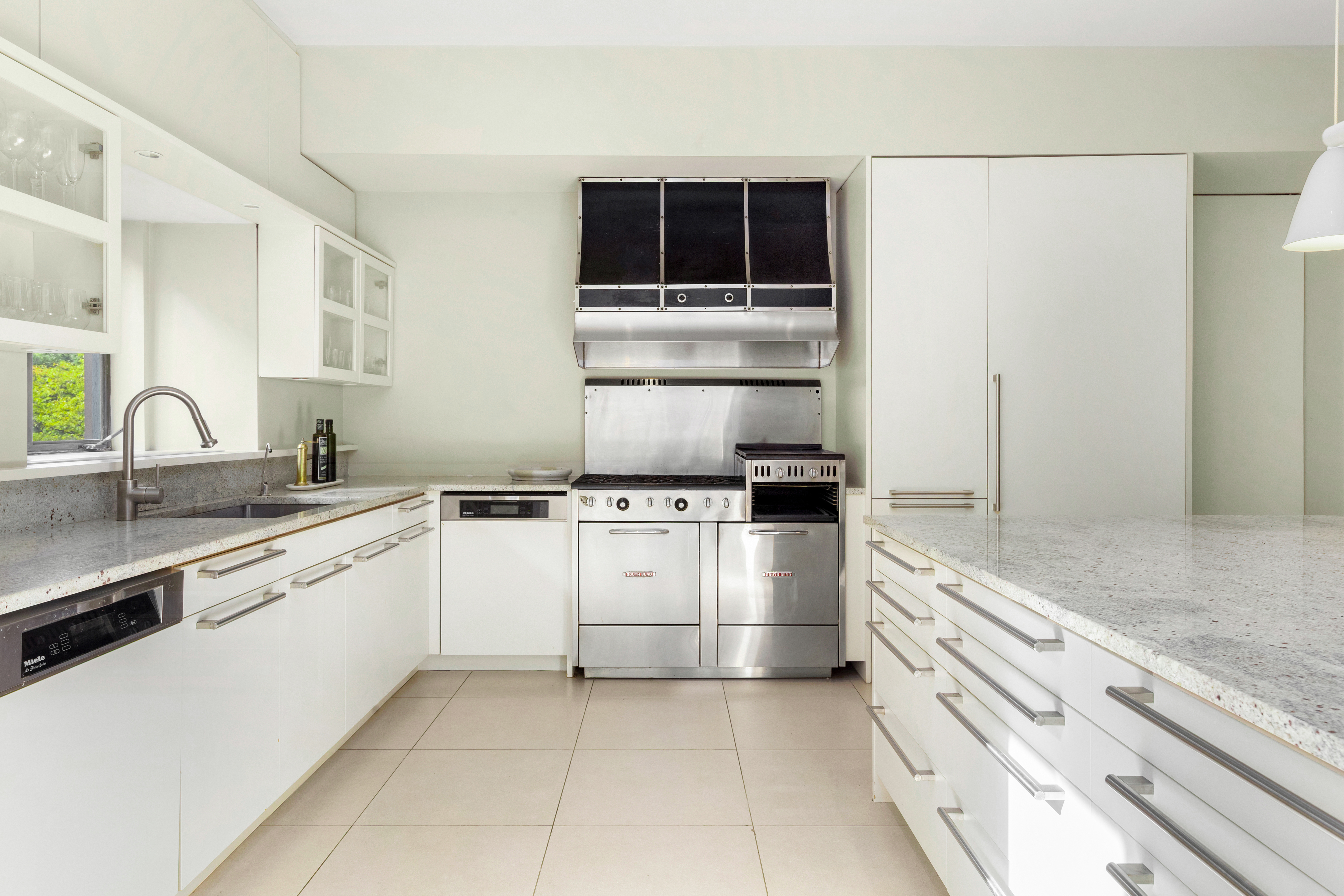 990 5th Avenue, Unit 4/5 Manhattan, NY 10075 - Photo 8 of 18 a kitchen with a sink stove and cabinets