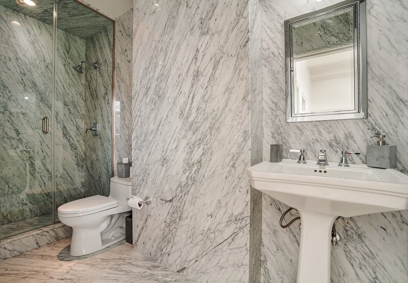 145 Spring Street, Unit PH Manhattan, NY 10012 - Photo 6 of 10 a bathroom with a sink toilet and a mirror