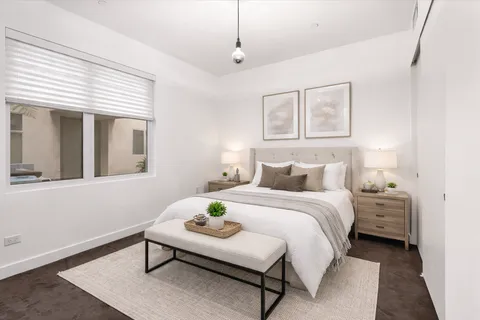 a bedroom with bed and a window